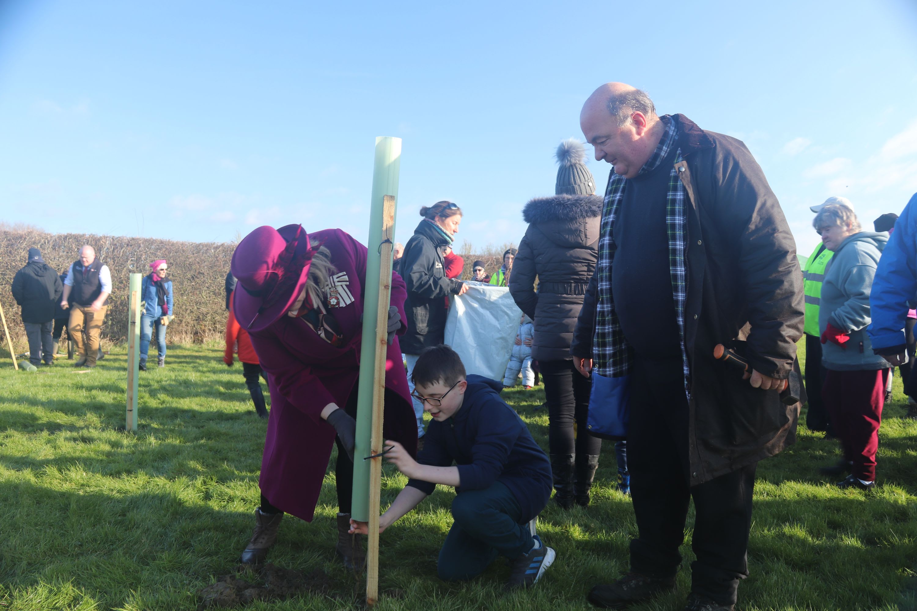 The Lord-Lieutenant of Bedfordshire planting a tree with members of the Wootton Parish community